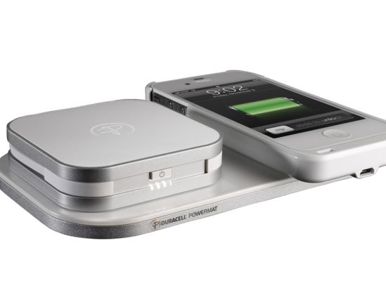 A fully charged smartphone on a wireless charging mat.