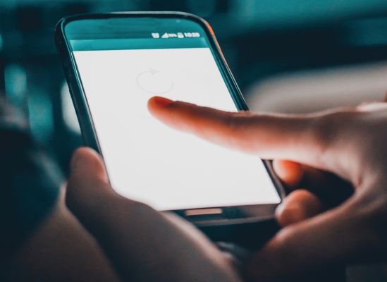 A person using their smartphone's touchscreen.