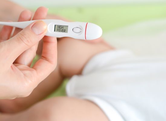 Photo of a thermometer that has a fever alert.