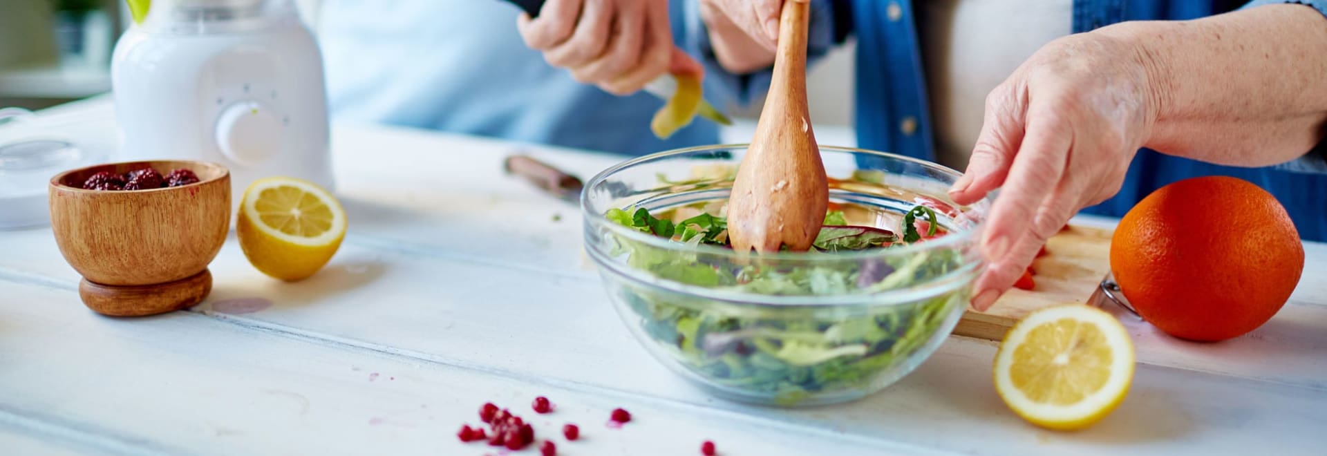 Woman making a salad. Healthy eating is essential for losing weight.