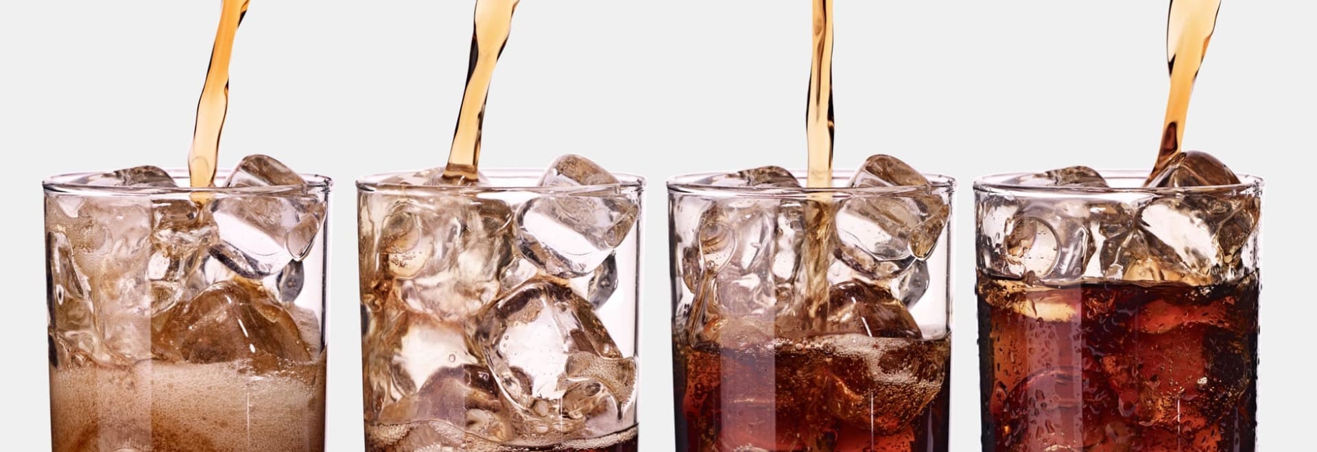 Diet sodas being poured into glasses.