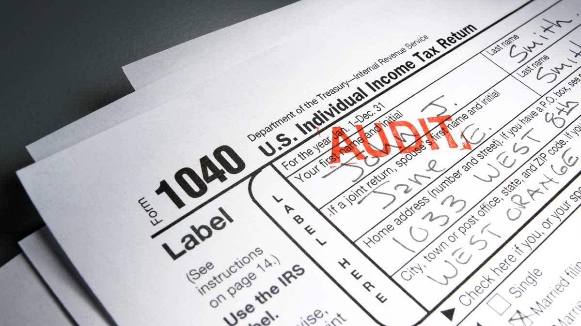 A photo of an IRS 1040 form with a tax audit stamp.