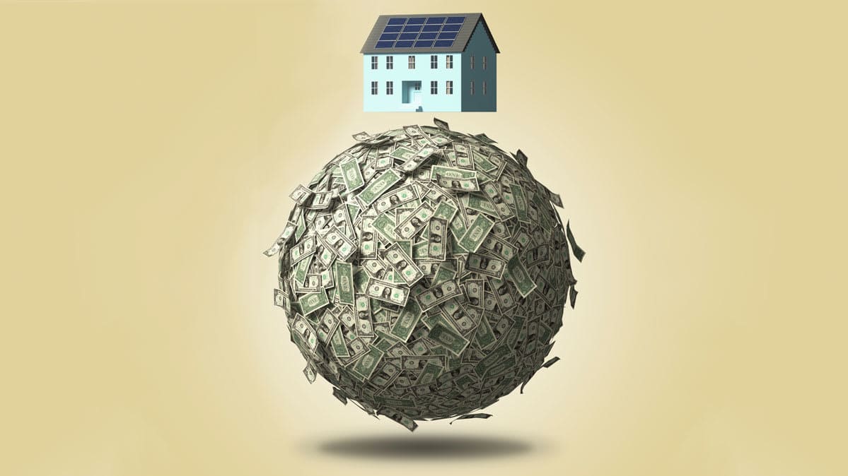 A house sitting on a ball of cash.