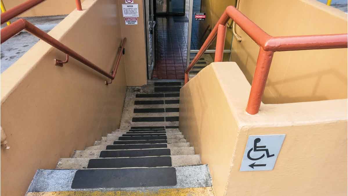 Photo of sign directing wheelchair users to take the stairs.