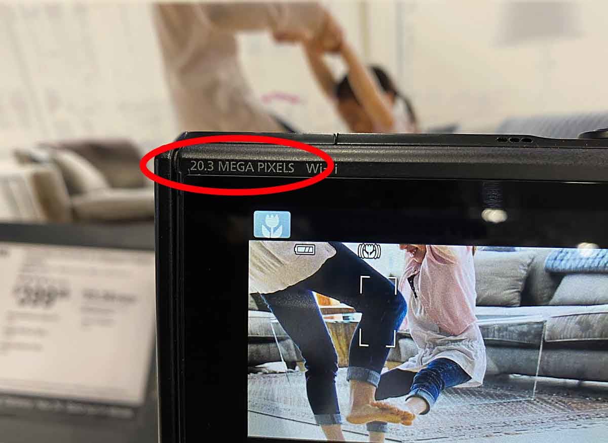detail of camera showing number of megapixels with adult and child dancing on screen