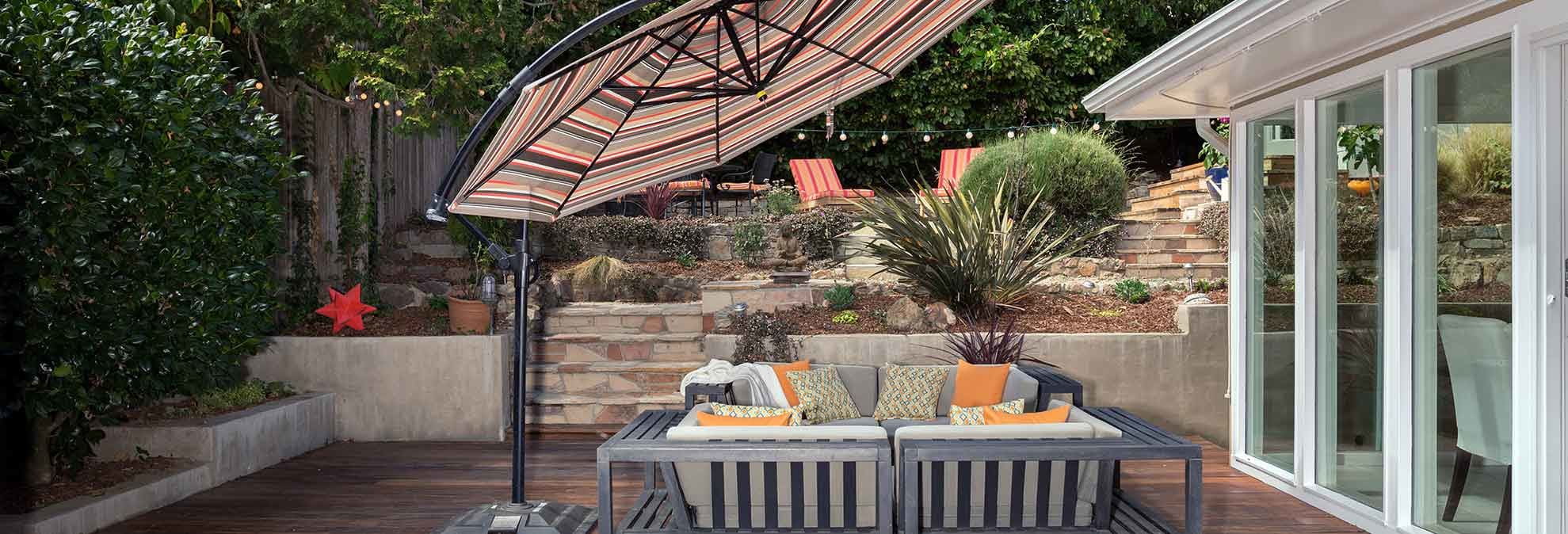 wooden patio with chairs and umbrella