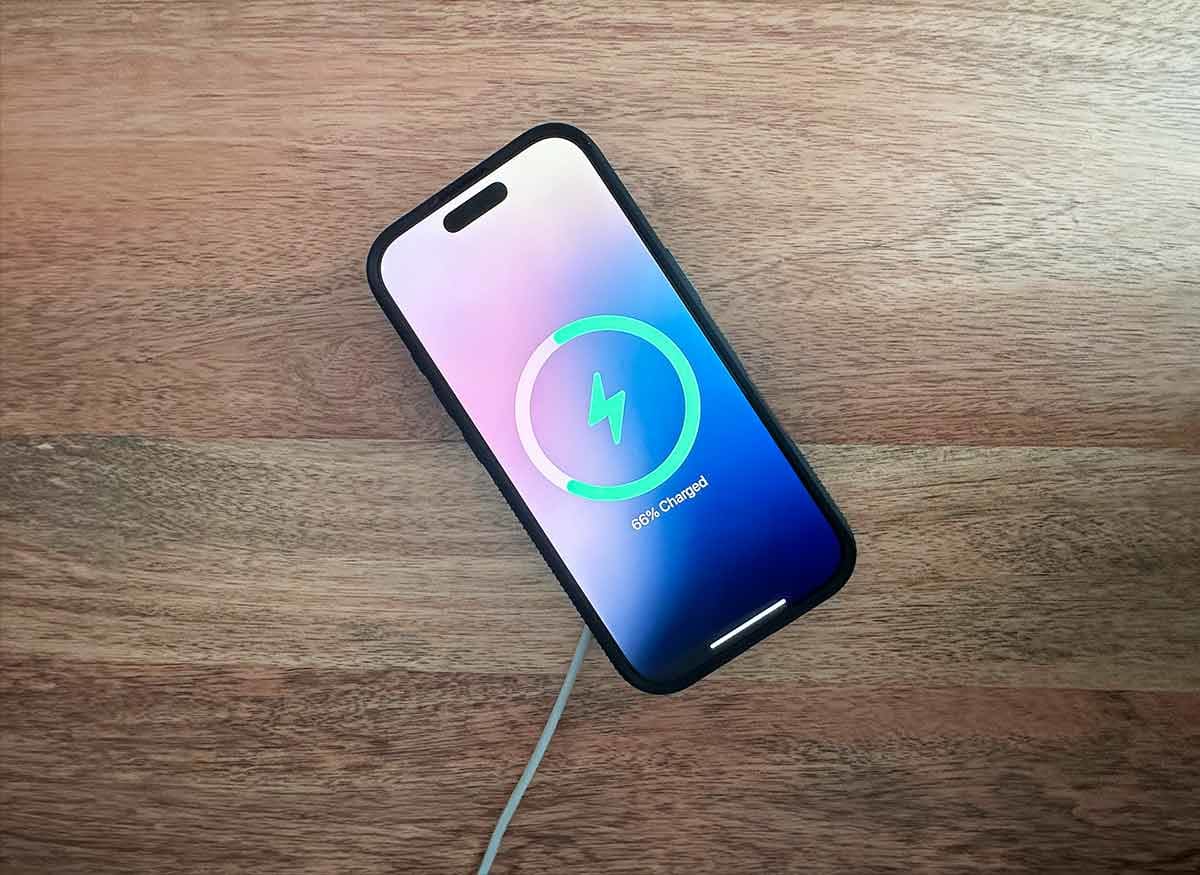 Apple iphone charges on MagSafe wireless charger.