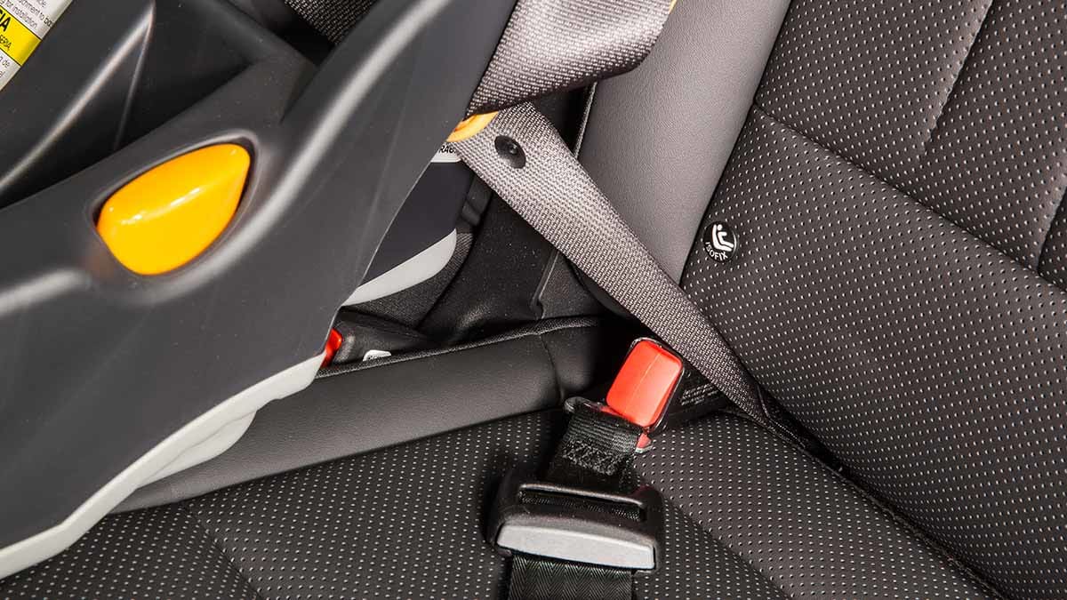 A close-up shows a child car seat installed by borrowing the LATCH from the seat next to it.