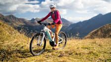 Woman with helmet on ebike mountain biking
