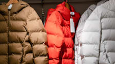 Puffer coats and jackets in a store