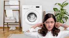 person with fingers in ears to block noise from washing machine behind them