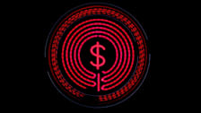 Overhead view of electric stove coil with dollar sign in the center