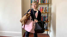 Consumer Reports writer Angela Lashbrook carries three of the eight duffel bags she evaluated.