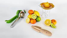 citrus squeezers with oranges and limes