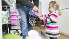Parent teaching their child to load the dishwasher