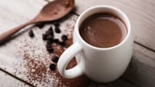 hot chocolate in a white mug with cocoa powder