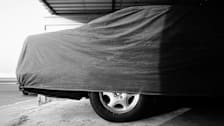 Close-Up Of Covered Car In Parking Garage