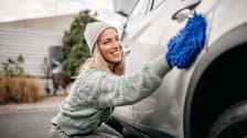 Woman cleaning her new car