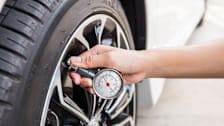 Person using a tire gauge.