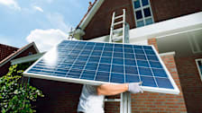 Workman installing a solar panel.