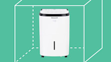 Honeywell TP70WKN Dehumidifier with cubic footage graphic behind it