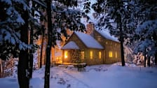 cedar shingled house covered in snow in winter