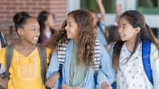 Three children at school walking outside