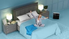Woman stretching in bed, refreshed from a good night's sleep.