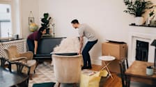 Couple arranging furniture in their living room