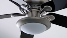 black and stainless ceiling fan with white ceiling behind it