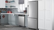 Amana ABB1924BRM in kitchen with dishwasher, sink, and grey and white cabinets