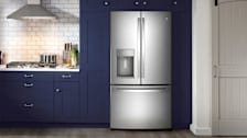 GE GFD28GYNFS french door refrigerator in kitchen with navy blue cabinets