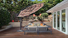 wooden patio with chairs and umbrella