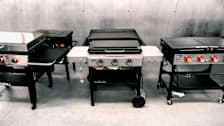 5 flat-top grills in room with stainless steel wall