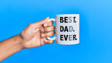hand holding a Best Dad Ever mug