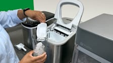 A Consumer Reports tester tries a sampling of nugget ice from the Frigidaire Icemaker EFIC117-SS