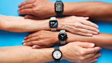 4 different hands and arms each with a different type of smartwatch on wrist