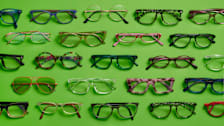 rows of various styles and colors of eyeglasses