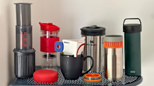 Various portable coffee makers on a metal table