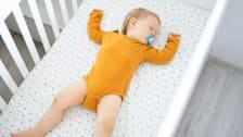A baby sleeping in a crib