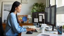 Person working at home at a desk with two monitors