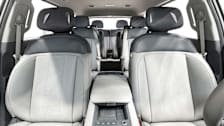 interior of 2024 Kia EV9 showing three rows of seating with grey fabric