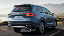 rear of a a 2024 Toyota Grand Highlander driving on a coastal road