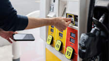 Close-up of person paying for gas at pump