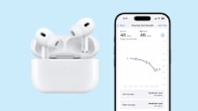 Apple AirPods Pro in case and iPhone showing screen with Hearing Test Results