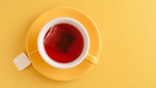 Yellow tea cup on a yellow background