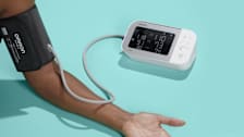 close up of person's arm with Omron blood pressure monitor