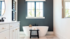 A bathroom with a deep colored painted accent wall