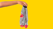 a pair of dirty socks handing from someone's hand