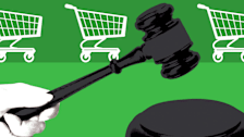 illustration of hand holding gavel with grocery carts in the background